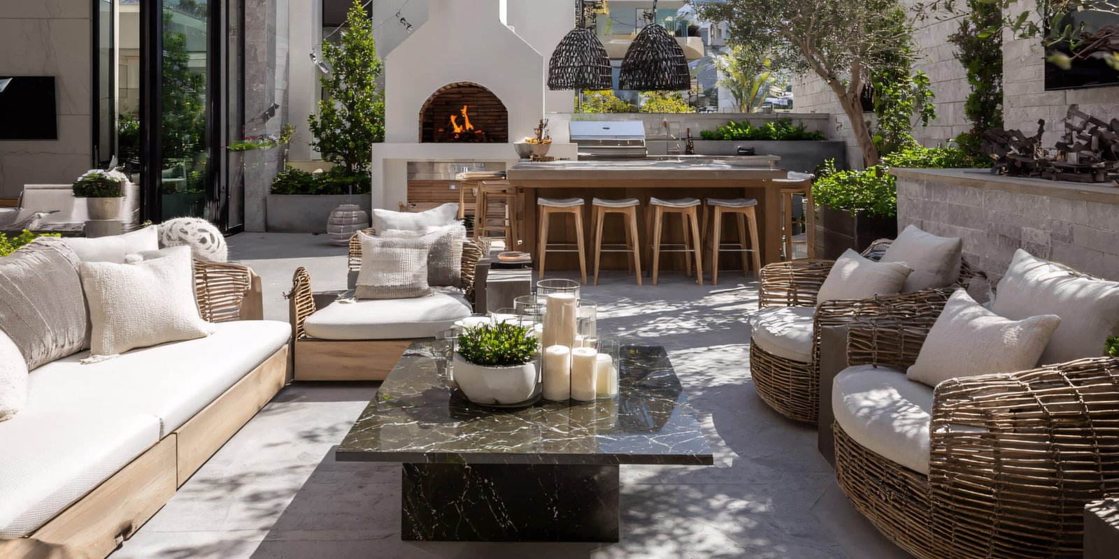 Patio lounge with woven chairs, marble table and outdoor kitchen