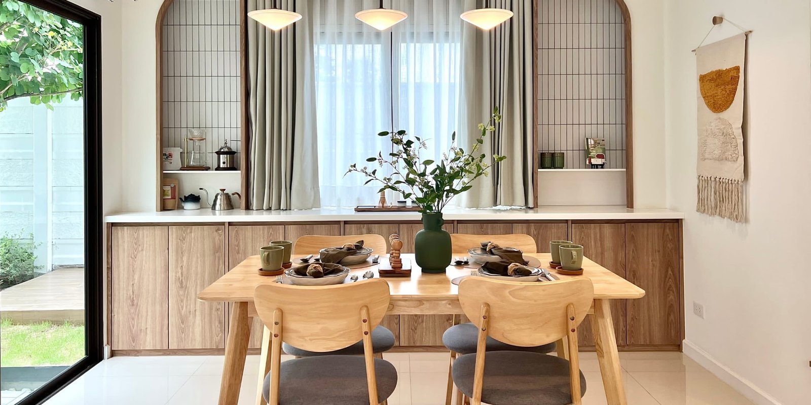 Scandinavian dining nook with light oak table and curved chairs